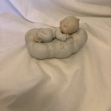 The Enesco Precious Moments Collection “Safe In The Arms Of Jesus” Figurine