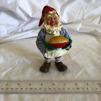 Man Holding Pie Figurine