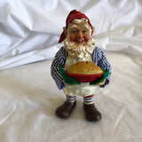 Man Holding Pie Figurine