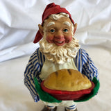 Man Holding Pie Figurine